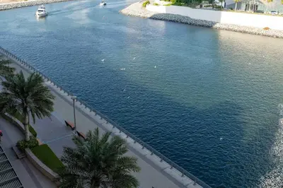 an aerial view of a river with a boat in it at Cozy and Stunning Waterfront One Bed in Dubai