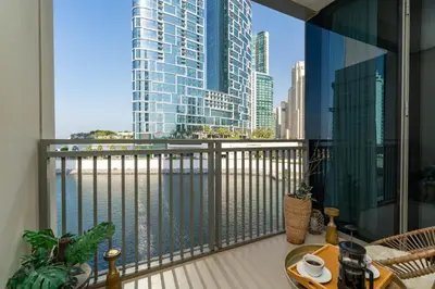 a balcony with a view of a city skyline at Cozy and Stunning Waterfront One Bed in Dubai