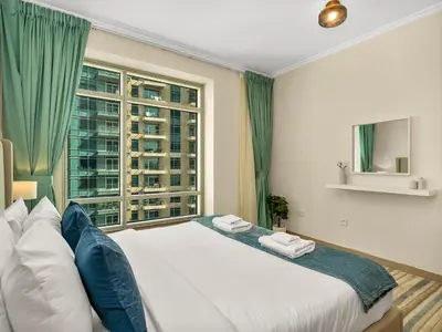 a bedroom with a large bed with a window at Prime Location - Amazing Burj Khalifa View in Dubai