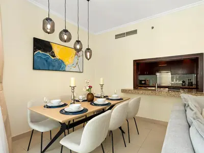 a dining room with a table and chairs at Prime Location - Amazing Burj Khalifa View in Dubai