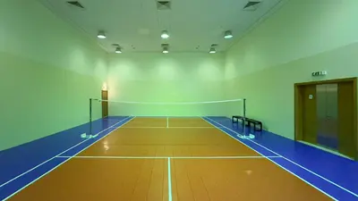 a gym with a tennis court with a net at Prime Location - Amazing Burj Khalifa View in Dubai