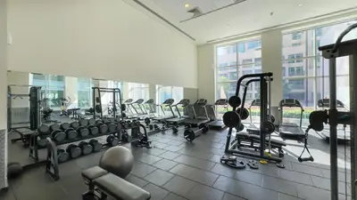 a gym with a row of treadms and machines at Prime Location - Amazing Burj Khalifa View in Dubai