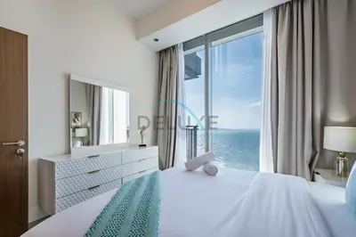 a bedroom with a large bed with a large window at Elegant 1BR in 5242 Tower 1, Dubai Marina by Deluxe Holiday Homes in Dubai