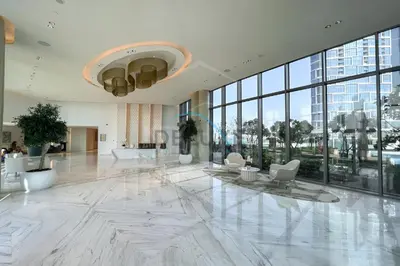 an office lobby with a large white marble floor and windows at Elegant 1BR in 5242 Tower 1, Dubai Marina by Deluxe Holiday Homes in Dubai