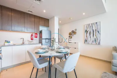 a kitchen and dining room with a table and chairs at Elegant 1BR in 5242 Tower 1, Dubai Marina by Deluxe Holiday Homes in Dubai