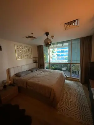 a bedroom with a bed and a large window at Fully upgraded luxurious one bedroom between Marina and JBR in Dubai
