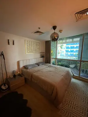 a bedroom with a bed and a large window at Fully upgraded luxurious one bedroom between Marina and JBR in Dubai