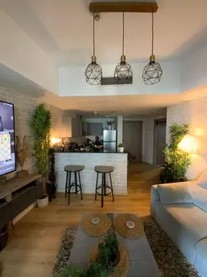 a living room with a couch and a kitchen at Fully upgraded luxurious one bedroom between Marina and JBR in Dubai