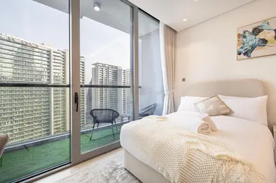 a bedroom with a bed and a large window at Outstanding New Studio With 2 Double Beds,In Downtown in Dubai