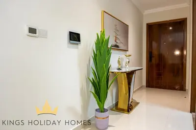 a hallway with a potted plant in front of a door at Luxury 2 Apartments Dunya tower Burj Khalifa St in Dubai