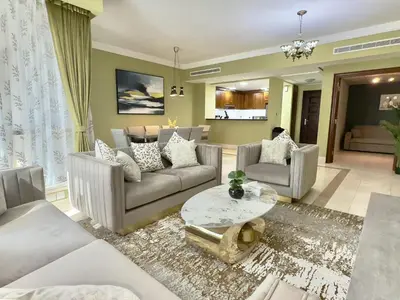 a living room with two couches and a table at Modern Apartment in Dubai Marina in Dubai