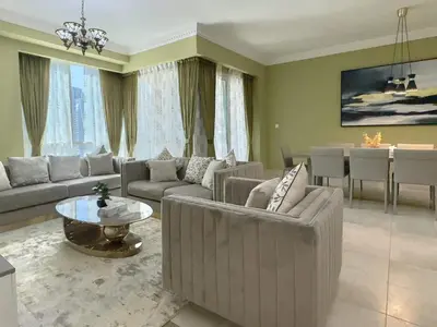 a living room with couches and a dining room at Modern Apartment in Dubai Marina in Dubai