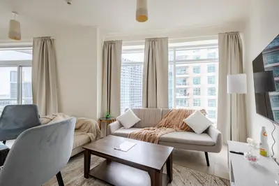 a living room with a couch and a table at 2BR Luxury Apartment in Downtown Opposite Mall and Fountain Entrance in Dubai