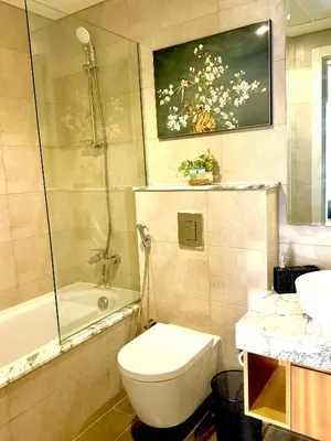 a bathroom with a toilet and a shower and a sink at Samani vacation homes 3018 in Dubai