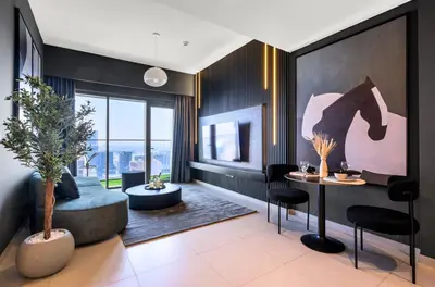 a living room with a couch and a table at Urban Zen Sky Suite 1BR - Dubai Mall Access by Maxx Value homes in Dubai