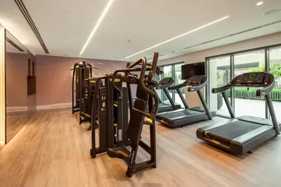 a gym with a row of treadmills and ellipticals at Urban Zen Sky Suite 1BR - Dubai Mall Access by Maxx Value homes in Dubai