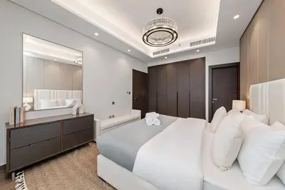 a bedroom with a large white bed and a large mirror at 10 Mins to Dubai Mall1BRBusiness Bay Heaven in Dubai