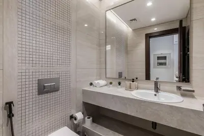 a bathroom with a sink and a mirror at 10 Mins to Dubai Mall1BRBusiness Bay Heaven in Dubai