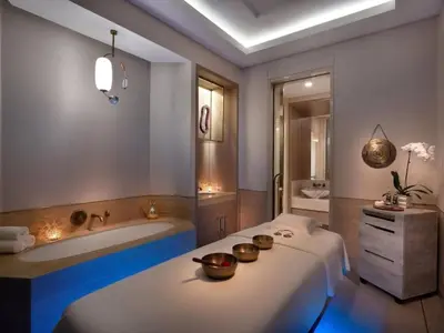 a bathroom with a tub and a bed with two bowls on it at SettlerHomes - Elegant Palm Tower Stay with the Sea View in Dubai