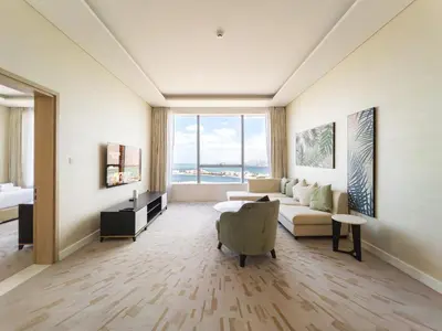 a living room with a couch and a table at SettlerHomes - Elegant Palm Tower Stay with the Sea View in Dubai