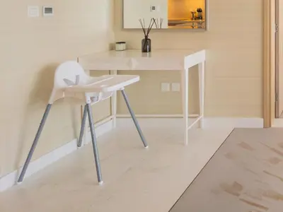 a white chair in a room with a desk at SettlerHomes - Elegant Palm Tower Stay with the Sea View in Dubai