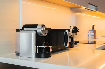 a coffee maker on a counter in a kitchen at SettlerHomes - Elegant Palm Tower Stay with the Sea View in Dubai