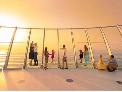 a group of people standing on the deck of a cruise ship at SettlerHomes - Elegant Palm Tower Stay with the Sea View in Dubai