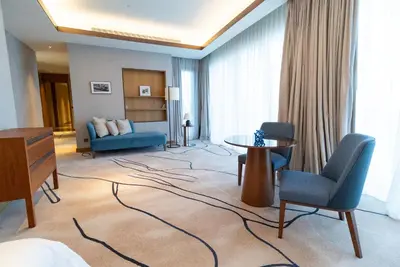 a hotel room with a bed and a table and chairs at ADDRESS Residences Dubai Opera at Downtown in Dubai