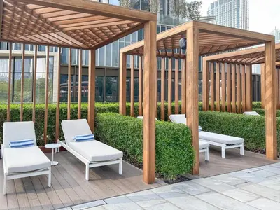 a wooden gazebo with two white chairs and avisor at ADDRESS Residences Dubai Opera at Downtown in Dubai