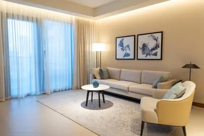 a living room with a couch and a table at ADDRESS Residences Dubai Opera at Downtown in Dubai