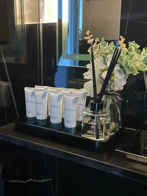 a tray with a group of cups and a vase of flowers at The Burj and Canal Views in Dubai