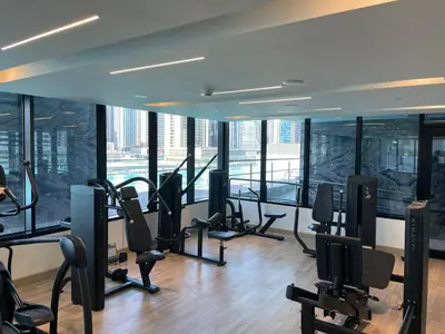 a gym with a bunch of treadmills and chairs at The Burj and Canal Views in Dubai