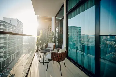 a balcony with a table and chairs on a building at 1BR Cozy and NEW brand JVC in Dubai