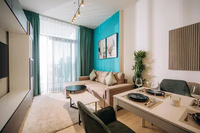 a living room with a couch and a table at 1BR Cozy and NEW brand JVC in Dubai