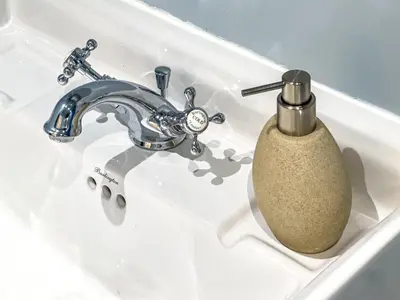 a bathroom sink with a faucet and a soap dispenser at Unique JBR Gem - Full Sea View - Designer's Choice - 5 min walk from JBR Beach in Dubai