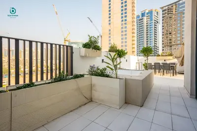 a balcony with a view of a city at Blue Breeze - Elegant 1BR with Private Jacuzzi & Terrace in JVC in Dubai