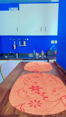 a kitchen with two mats on a wooden table at Aesthetic Blue Studio on Marina Walk in Dubai