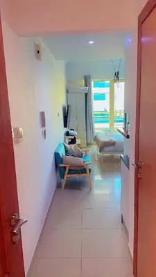 a living room with a couch and a chair in a room at Aesthetic Blue Studio on Marina Walk in Dubai