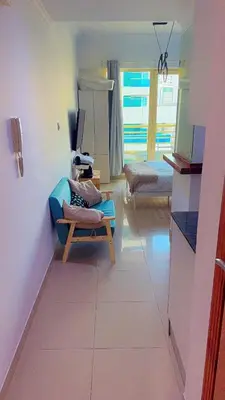 a room with a room with two beds and a table at Aesthetic Blue Studio on Marina Walk in Dubai