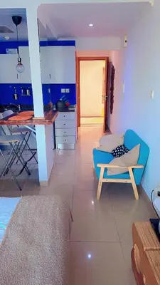 a living room with a blue couch and a table at Aesthetic Blue Studio on Marina Walk in Dubai