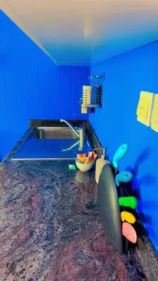 a blue kitchen with a sink and a counter at Aesthetic Blue Studio on Marina Walk in Dubai