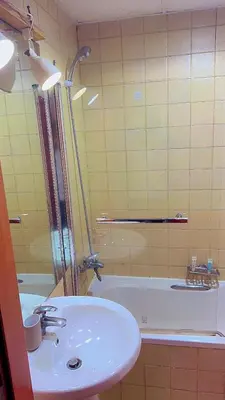 a bathroom with a sink and a shower and a tub at Aesthetic Blue Studio on Marina Walk in Dubai