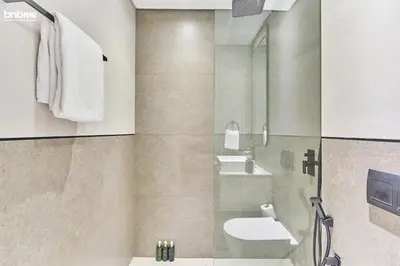 a bathroom with a sink and a toilet and a shower at bnbmehomes - Oxford Terraces in Dubai