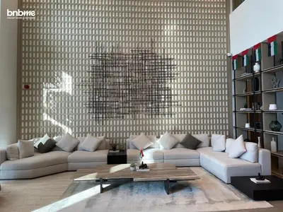 a living room with a couch and a table at bnbmehomes - Oxford Terraces in Dubai