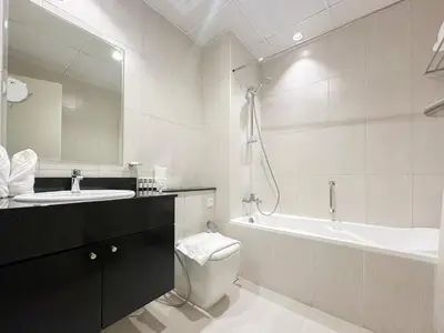a bathroom with a sink and a toilet and a tub at Bespoke Holiday Homes - High floor studio in Tower 108 JVC in Dubai