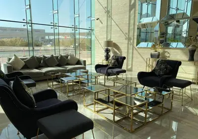 a lobby with a couch and chairs and tables at Bespoke Holiday Homes - High floor studio in Tower 108 JVC in Dubai