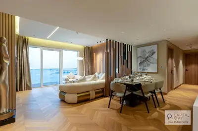 a living room with a table and a couch at Luxury Beachfront 3 Bed Apt in Dubai JBR in Dubai