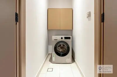 a washer and dryer in a laundry room at Luxury Beachfront 3 Bed Apt in Dubai JBR in Dubai
