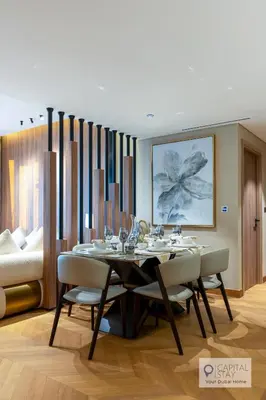 a dining room with a table and chairs at Luxury Beachfront 3 Bed Apt in Dubai JBR in Dubai
