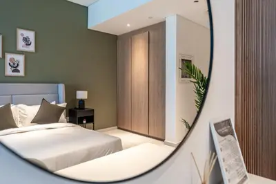 a bedroom with a bed and a mirror at HAVN - New Studio Business Bay, Burj Khalifa View in Dubai